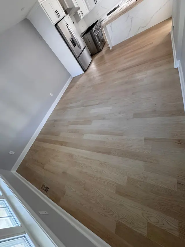 Wood-look flooring next to a kitchen.