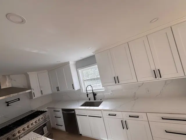 Kitchen view showing cabinets, countertop, sink, and appliances.